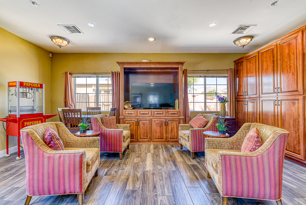 lounge area with chairs, a tv and a popcorn maker