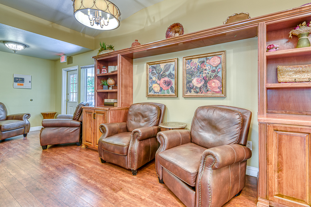 room with recliner chairs and small bookcase